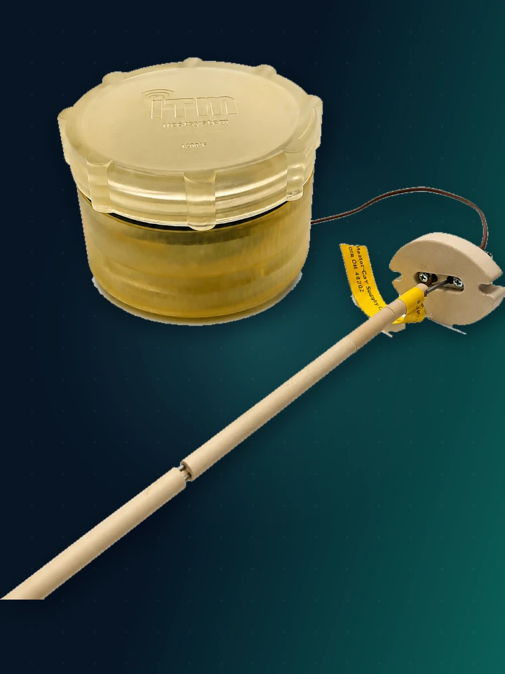 ITM Wireless Thermocouple Node HALT — a translucent amber jar-shaped enclosure with a ribbed screw lid embossed ITM, wired to a ceramic-tipped thermocouple probe on a long rod